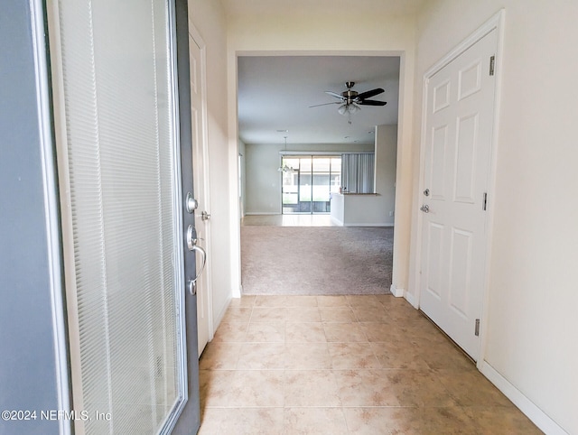 corridor featuring light colored carpet