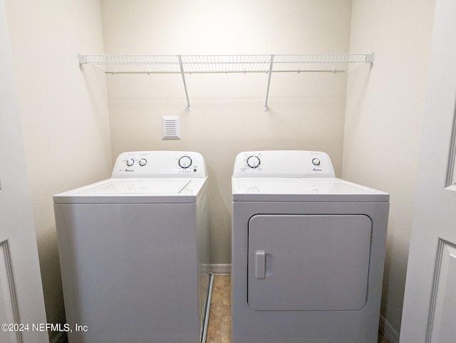 clothes washing area with tile patterned flooring and washer and clothes dryer