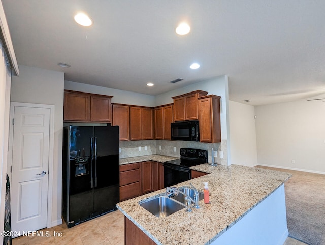 kitchen featuring decorative backsplash, light colored carpet, sink, kitchen peninsula, and black appliances