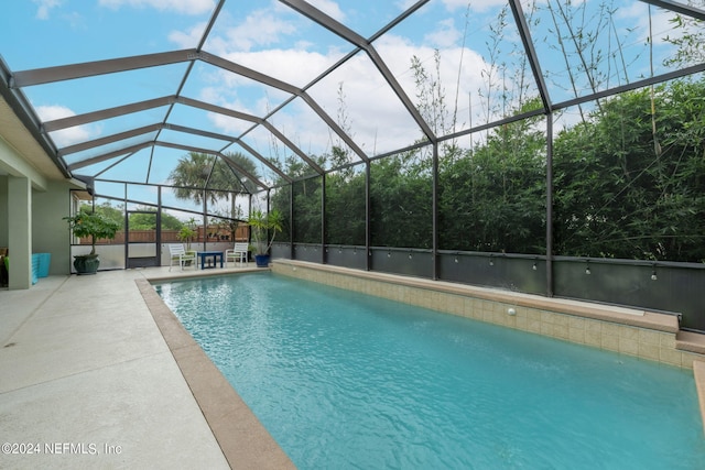 view of swimming pool with a lanai and a patio area