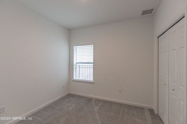 unfurnished bedroom featuring a closet and carpet