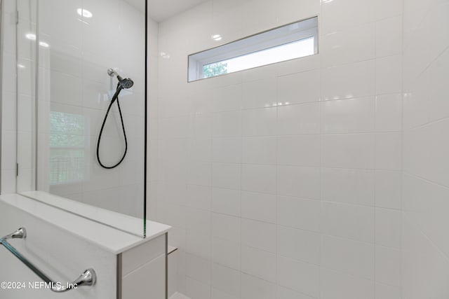 bathroom with tiled shower