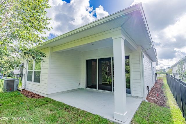 rear view of house with a patio area and central AC