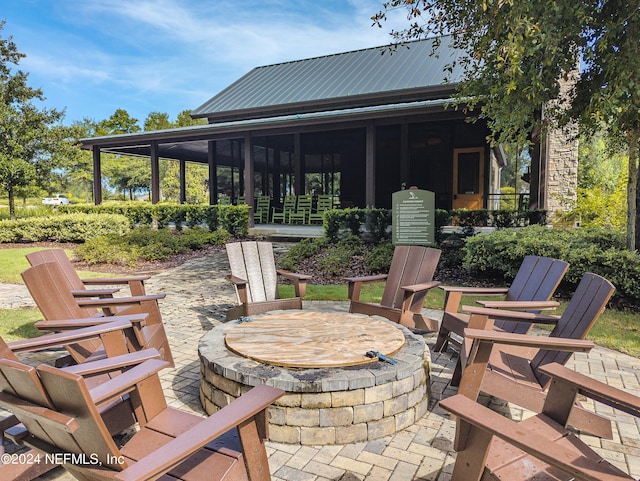 view of patio / terrace featuring an outdoor fire pit