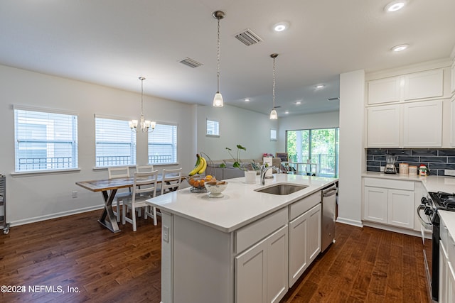 kitchen with a kitchen island with sink, dark wood-type flooring, stainless steel appliances, and sink