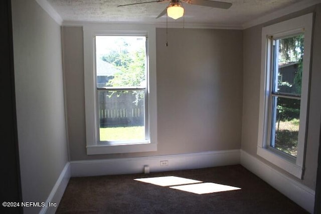 carpeted empty room with crown molding, a textured ceiling, and ceiling fan