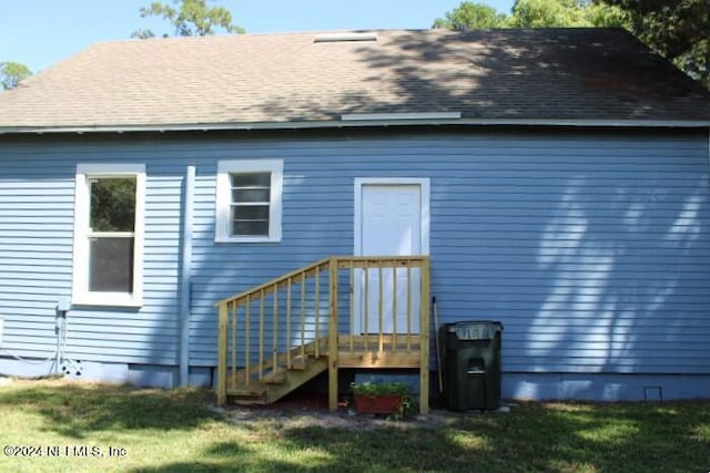 rear view of house with a lawn