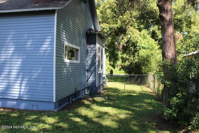 view of side of home featuring a yard