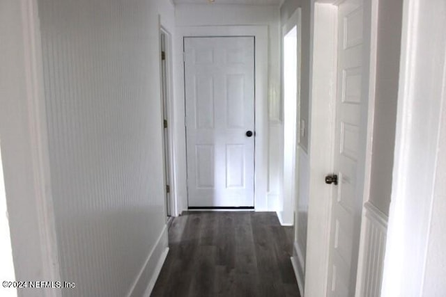 hallway with dark hardwood / wood-style flooring