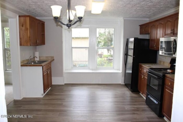 kitchen featuring black range with electric cooktop, plenty of natural light, sink, and dark hardwood / wood-style flooring