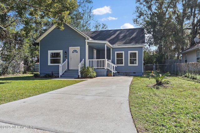 ranch-style house with driveway, a front lawn, crawl space, and fence