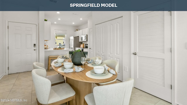 dining room featuring light tile patterned flooring and recessed lighting