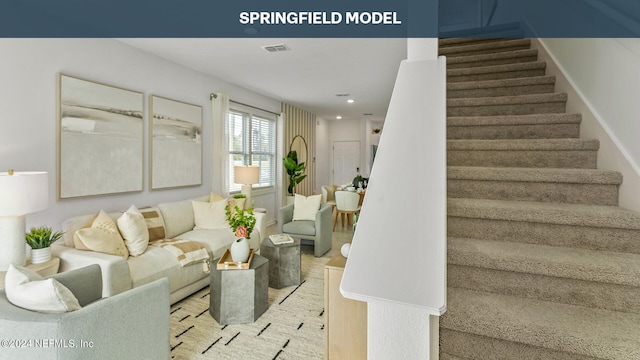 living room with stairs, visible vents, and recessed lighting