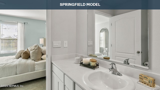 bathroom with vanity and ensuite bath