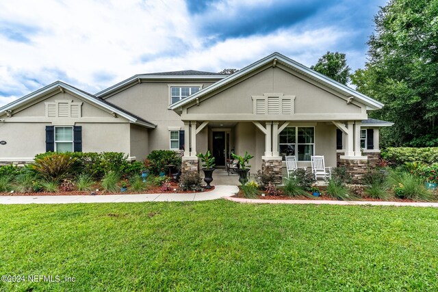 craftsman-style home with covered porch and a front yard