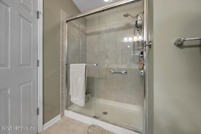 bathroom featuring tile patterned floors and a shower with door