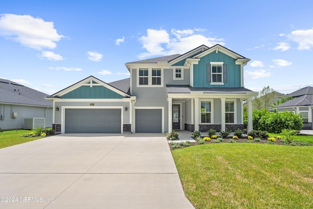 view of front of house featuring driveway, a garage, stone siding, a front lawn, and board and batten siding