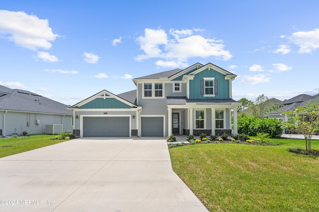 view of front of house featuring board and batten siding, concrete driveway, an attached garage, and a front lawn