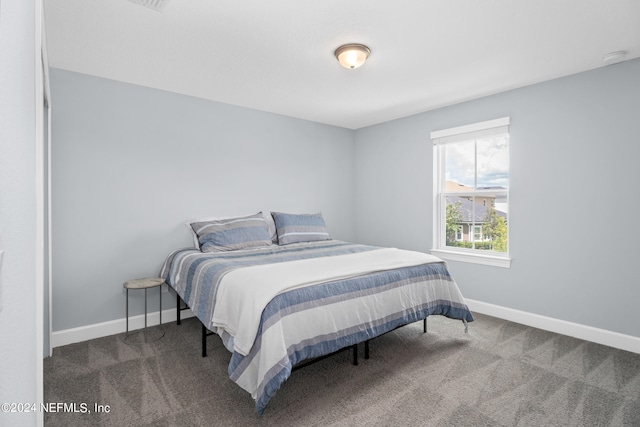 bedroom featuring carpet and baseboards