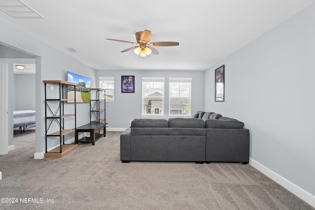 carpeted living area featuring ceiling fan, visible vents, and baseboards