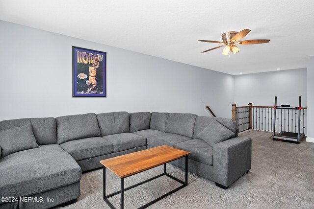 carpeted living room featuring ceiling fan