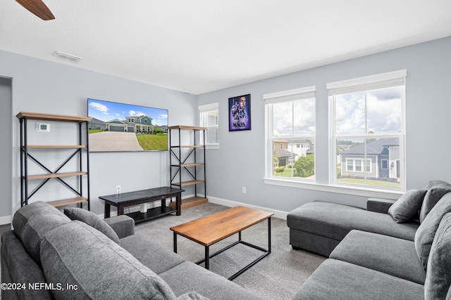 living room with carpet and ceiling fan