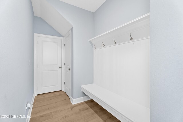 mudroom with lofted ceiling and light hardwood / wood-style flooring