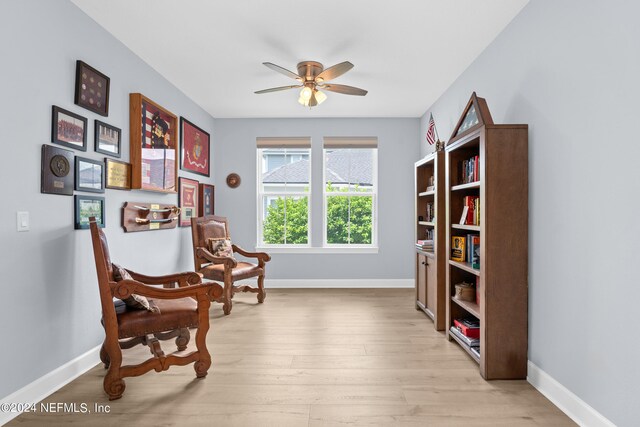 living area with light wood-type flooring and ceiling fan