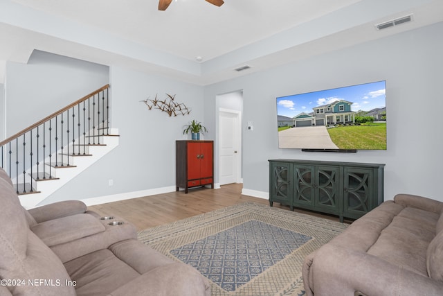 living room featuring wood-type flooring and ceiling fan