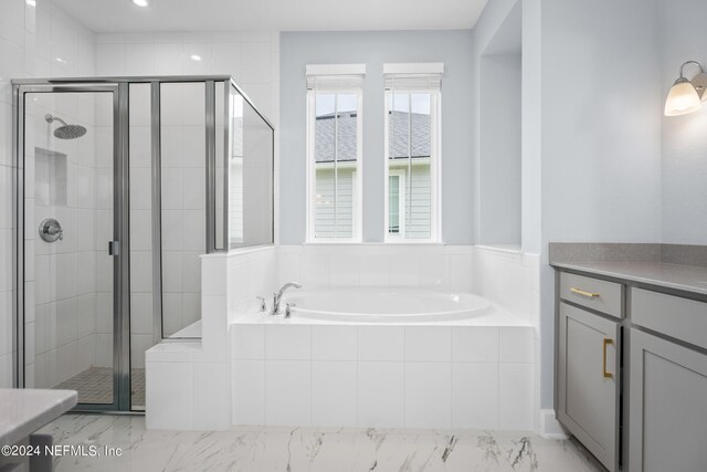 bathroom featuring separate shower and tub and vanity