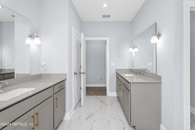 full bathroom featuring marble finish floor, visible vents, a sink, and baseboards