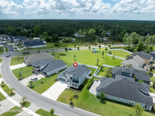 aerial view featuring a forest view and a residential view