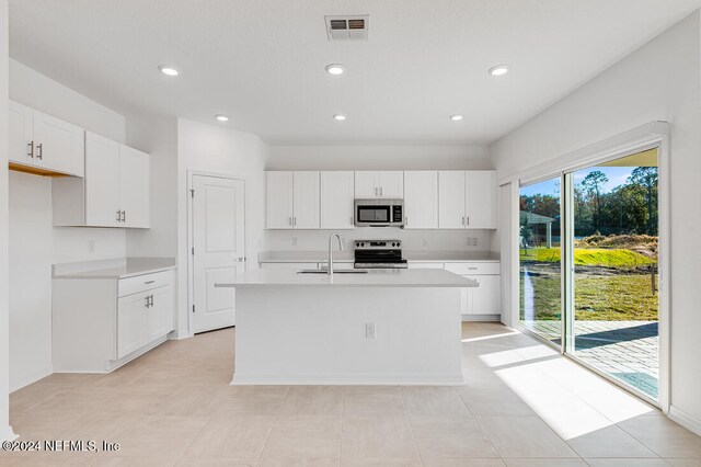 kitchen featuring white cabinetry, a center island with sink, sink, and appliances with stainless steel finishes