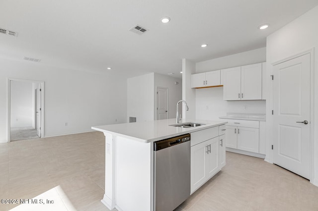 kitchen with a center island with sink, stainless steel dishwasher, white cabinetry, and sink