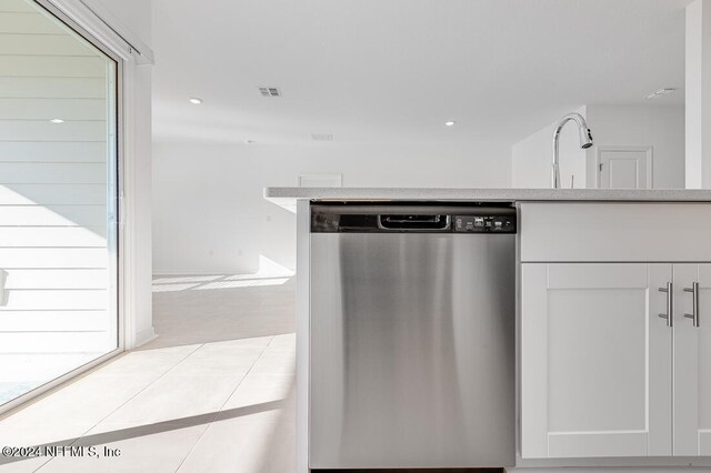 kitchen featuring dishwasher and white cabinetry