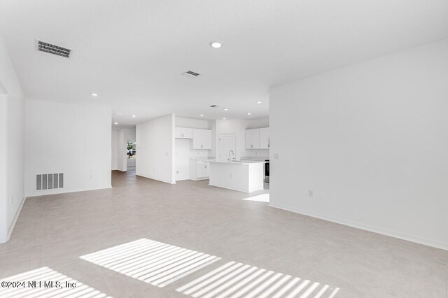 unfurnished living room with sink