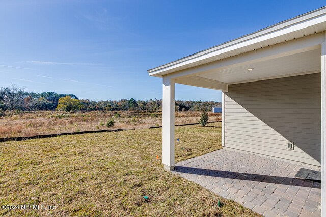 view of yard with a patio and a rural view