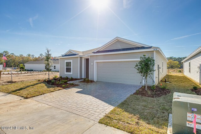 ranch-style home with a front yard and a garage