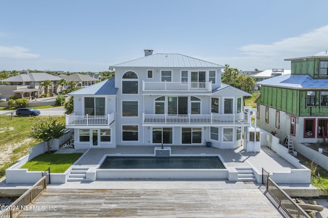 back of house with a balcony and a patio area