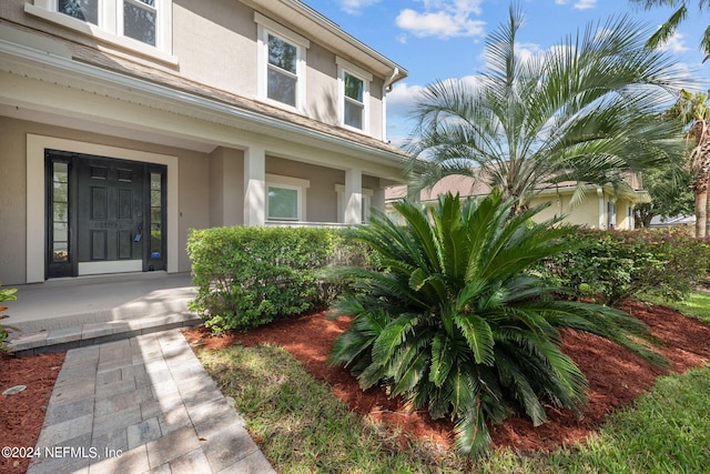 property entrance with covered porch