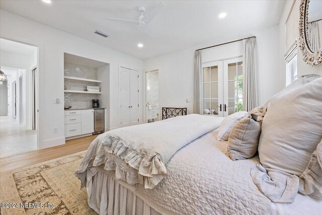 bedroom with light hardwood / wood-style flooring, french doors, access to outside, ceiling fan, and refrigerator