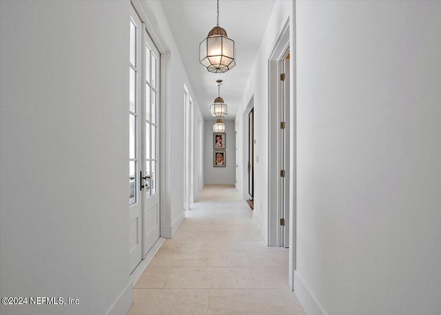 hall featuring light tile patterned floors