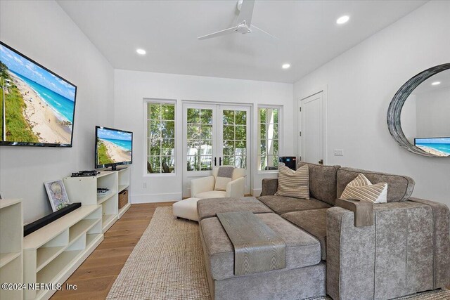 living room with ceiling fan, hardwood / wood-style flooring, and french doors