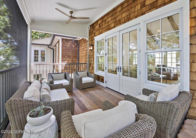 sunroom with ceiling fan, french doors, and lofted ceiling