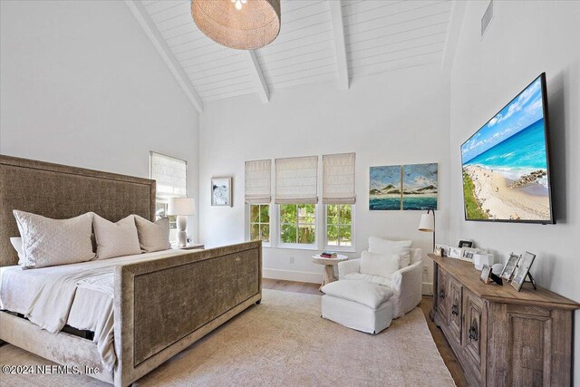 bedroom with hardwood / wood-style floors, beam ceiling, high vaulted ceiling, and wooden ceiling