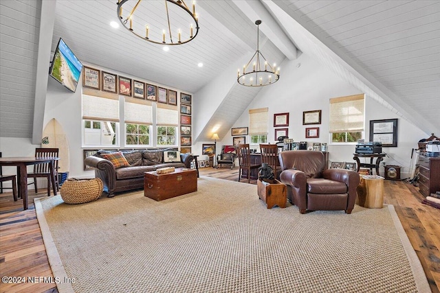 living room with hardwood / wood-style floors, high vaulted ceiling, a notable chandelier, and beamed ceiling