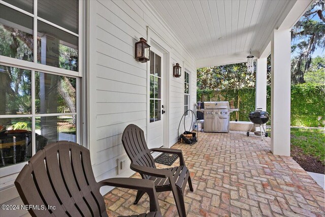 view of patio / terrace with a grill and a porch