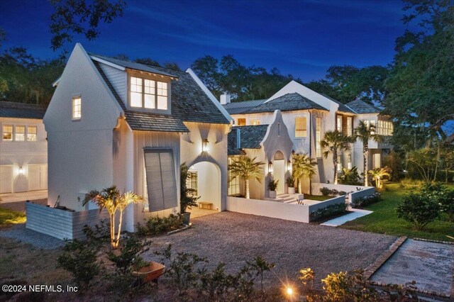 view of back house at twilight