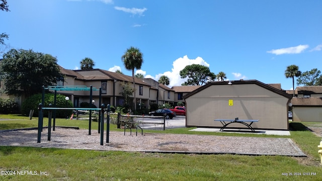 surrounding community featuring a playground and a yard