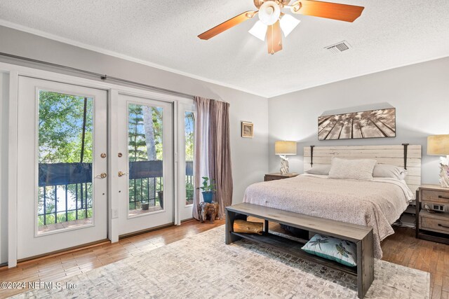 bedroom with ceiling fan, light hardwood / wood-style flooring, and multiple windows